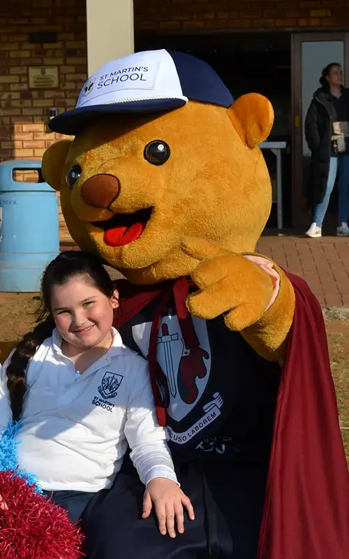 Student enjoying the Winter Sports Day with St Martin's School Mascot
