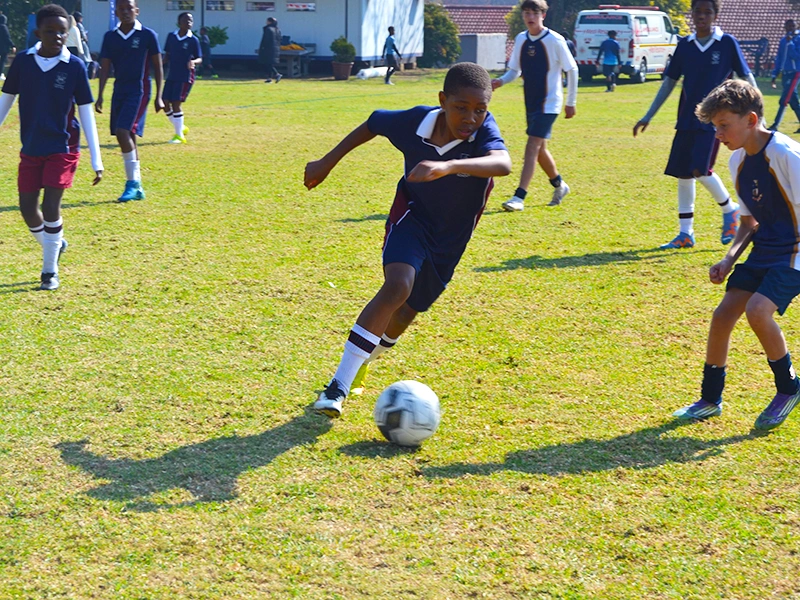 boy dribbles a soccer ball
