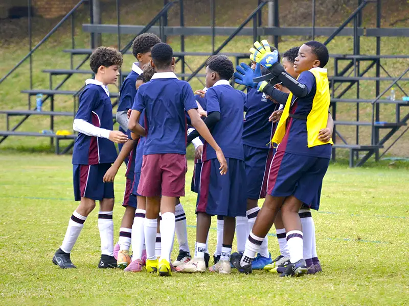 boys soccer team huddle to discuss strategy