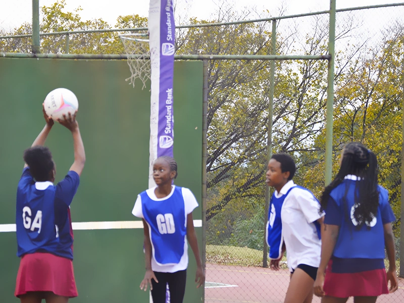 girl takes aim at the netball net