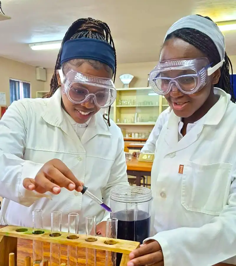 girls performing a science experiment