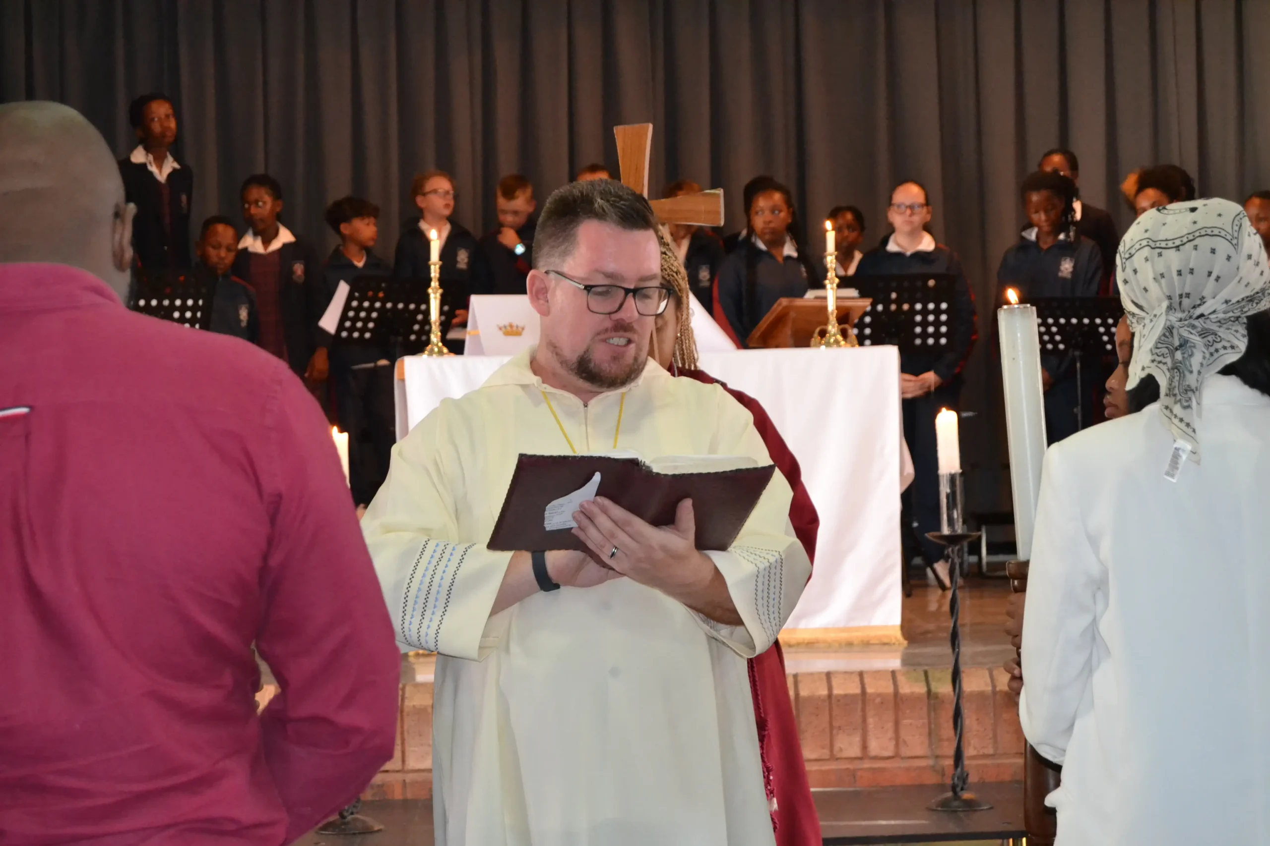 School principal reads a verse from the Bible