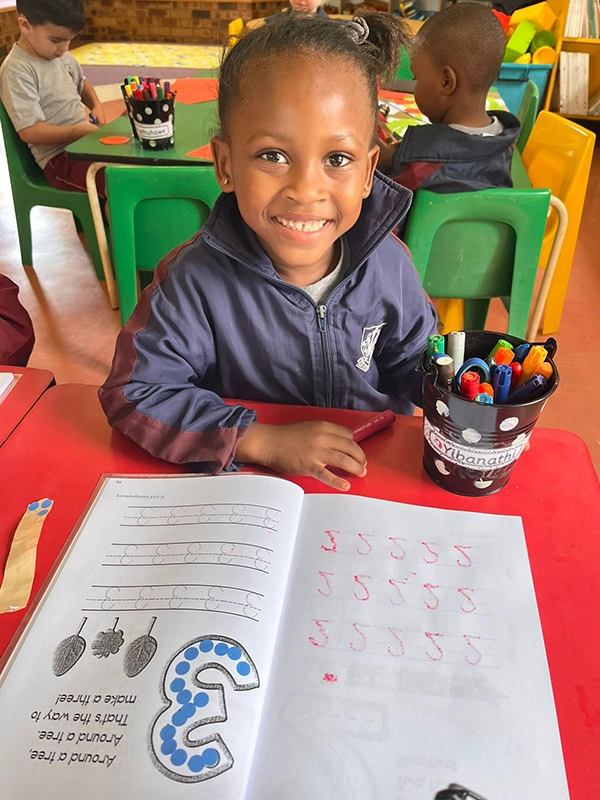 Happy student shows off his completed class exercise